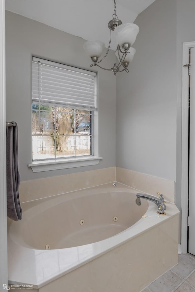 full bathroom featuring tile patterned floors, a chandelier, and a jetted tub