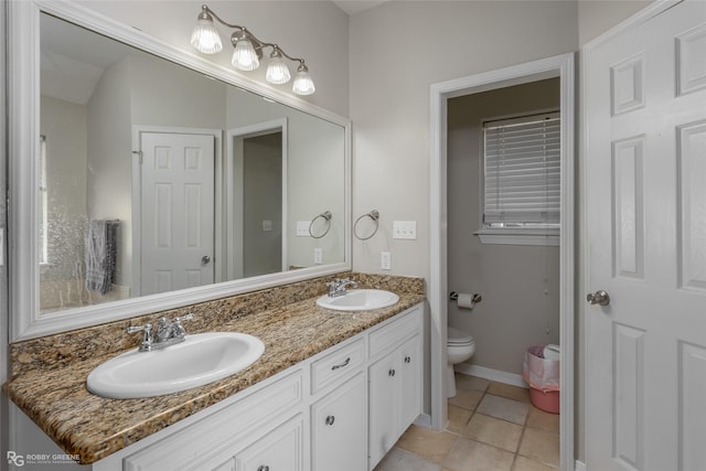 full bath featuring double vanity, tile patterned flooring, toilet, and a sink