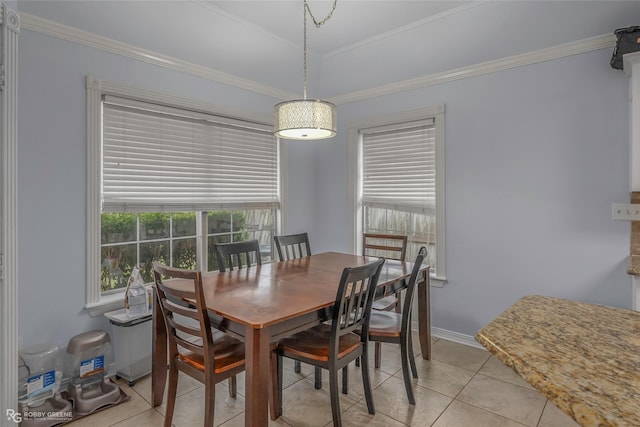 dining area with light tile patterned floors, crown molding, and baseboards