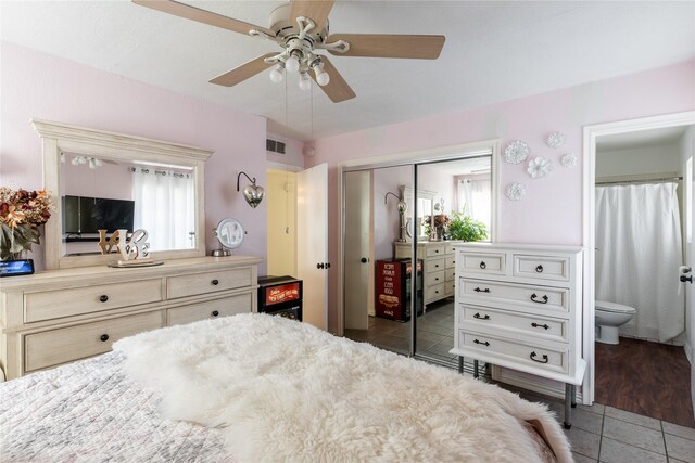 1306 N Floyd Rd, Richardson, TX 75080 - bedroom with tile patterned flooring, visible vents, connected bathroom, ceiling fan, and a closet