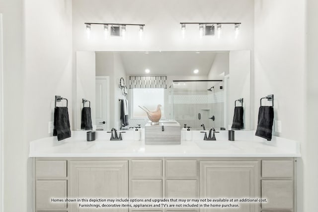 full bathroom with double vanity, a stall shower, and a sink