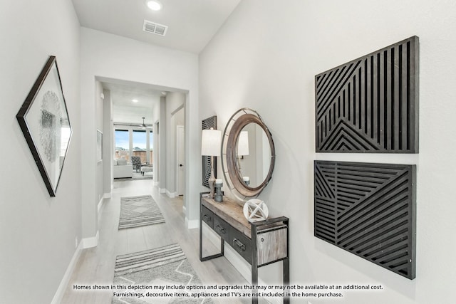 corridor with recessed lighting, visible vents, baseboards, and wood finished floors