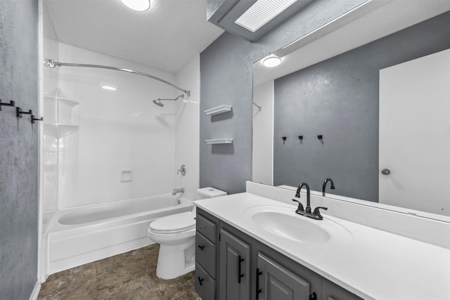 bathroom featuring bathtub / shower combination, toilet, vanity, and a textured wall