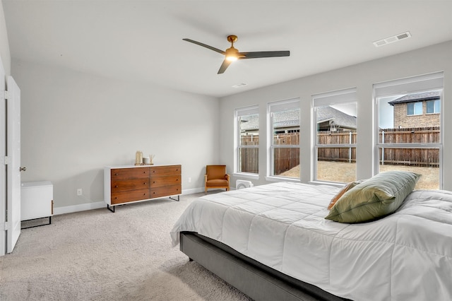 carpeted bedroom featuring visible vents, a ceiling fan, and baseboards