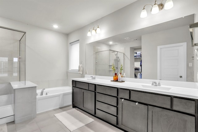 full bathroom with double vanity, a stall shower, a garden tub, and a sink