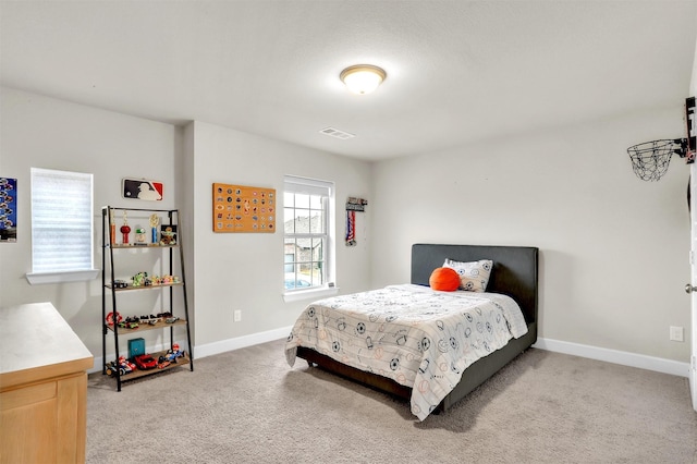 carpeted bedroom featuring visible vents and baseboards