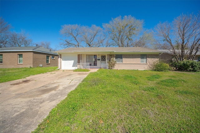 ranch-style home with a front lawn, a porch, concrete driveway, an attached garage, and brick siding