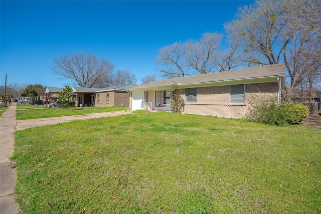 single story home with brick siding, a garage, driveway, and a front lawn