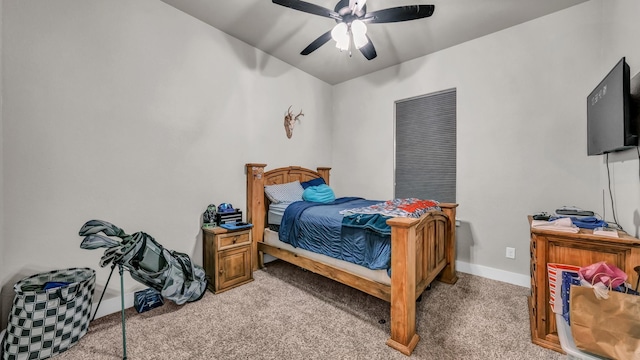 bedroom with light colored carpet, a ceiling fan, and baseboards