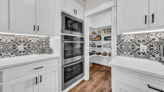 kitchen with backsplash, appliances with stainless steel finishes, and light countertops