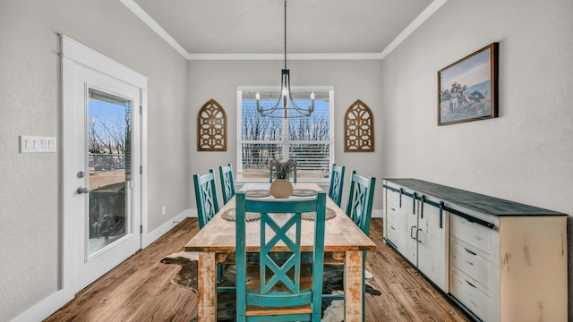 dining space with wood finished floors, baseboards, and ornamental molding