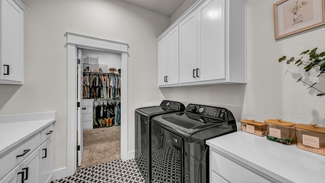 laundry room with cabinet space and washer and clothes dryer