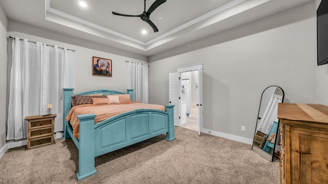 bedroom featuring baseboards, a tray ceiling, recessed lighting, ceiling fan, and light colored carpet