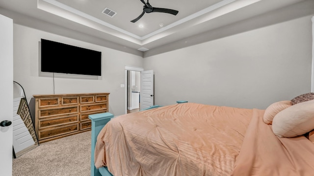 bedroom with visible vents, carpet flooring, a raised ceiling, and ceiling fan