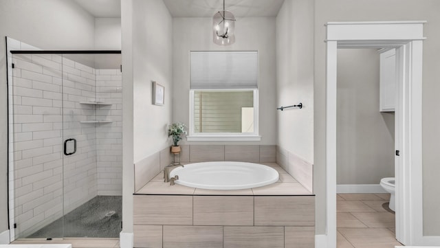 full bath featuring tile patterned floors, a garden tub, toilet, and a stall shower