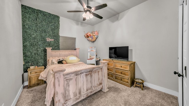 bedroom featuring light colored carpet, baseboards, and ceiling fan