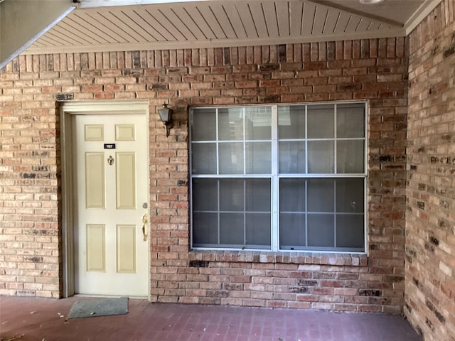 property entrance with brick siding