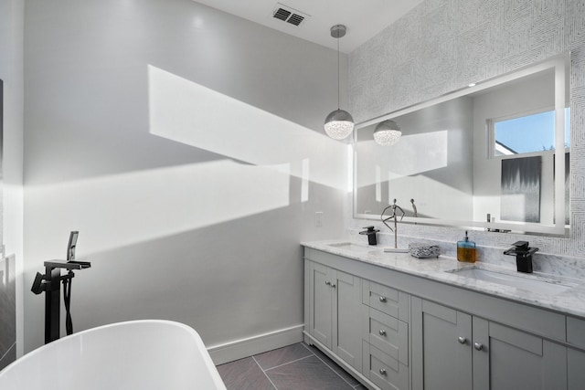 20055 Hill Ln, Kemp, TX 75143 - bathroom featuring double vanity, a soaking tub, marble look tiles, and baseboards