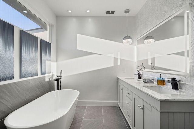 20055 Hill Ln, Kemp, TX 75143 - bathroom with a freestanding tub, double vanity, and baseboards