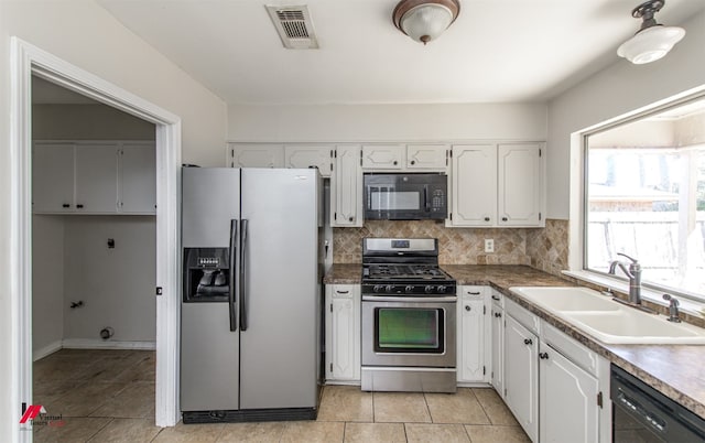 kitchen featuring black appliances, white cabinets, visible vents, and a sink