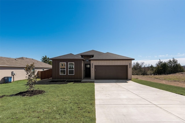 view of front of home with a front yard, roof with shingles, concrete driveway, a garage, and board and batten siding