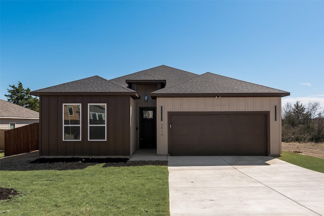 view of front of home with concrete driveway, fence, a garage, and a shingled roof