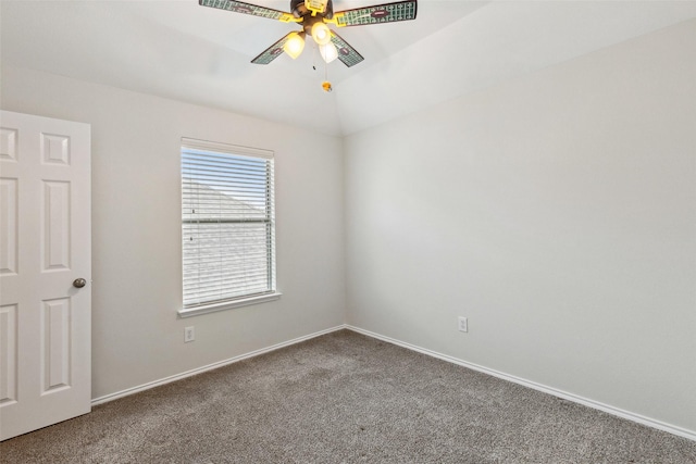 carpeted empty room featuring vaulted ceiling, a ceiling fan, and baseboards