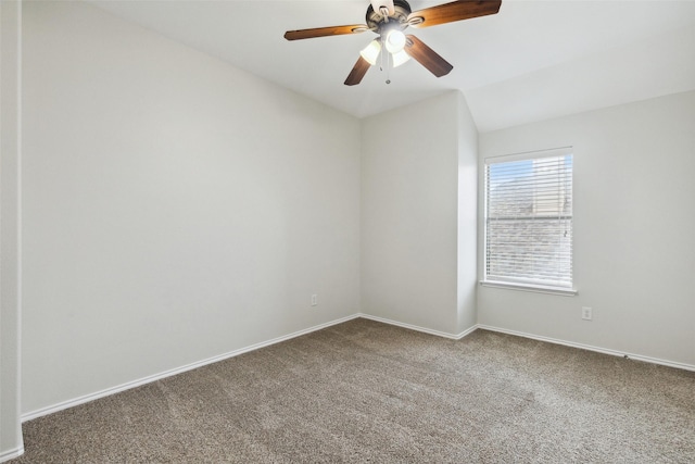 carpeted spare room with ceiling fan, lofted ceiling, and baseboards