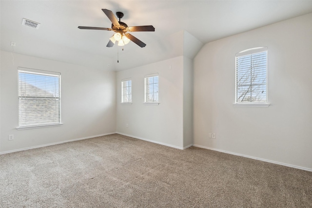 carpeted empty room with visible vents, baseboards, and ceiling fan