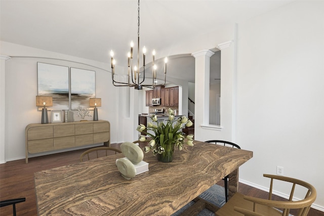 dining area with dark wood-style floors, decorative columns, baseboards, a chandelier, and stairs