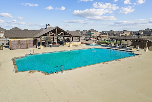 pool with a community hot tub, a pergola, a gazebo, a residential view, and a patio area