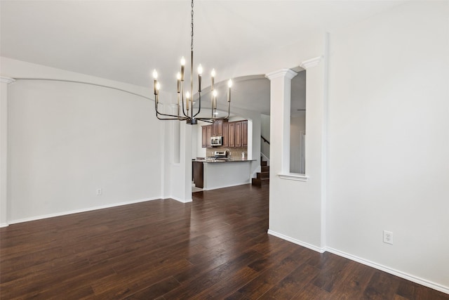 unfurnished dining area with stairway, baseboards, dark wood-style floors, and ornate columns