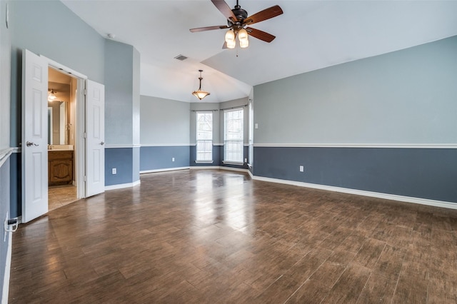 unfurnished room featuring visible vents, baseboards, a ceiling fan, and wood finished floors