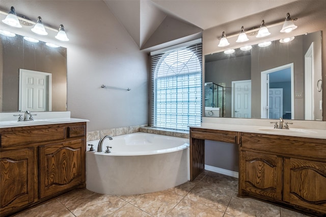 bathroom with a garden tub, vaulted ceiling, a stall shower, and a sink