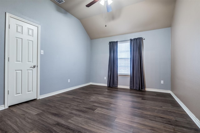 unfurnished room with visible vents, baseboards, lofted ceiling, dark wood-style floors, and a ceiling fan