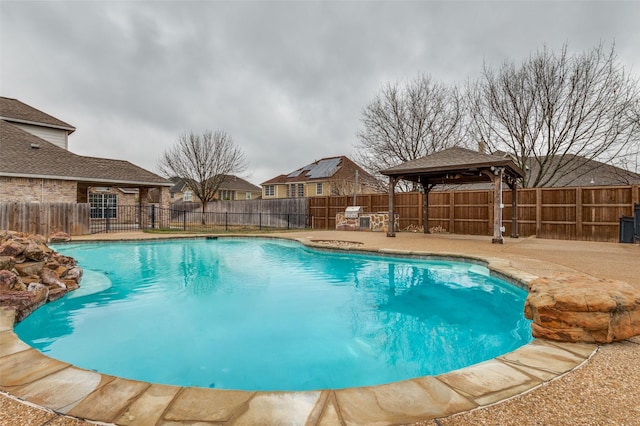 view of swimming pool featuring a gazebo, a fenced in pool, a fenced backyard, and a patio area