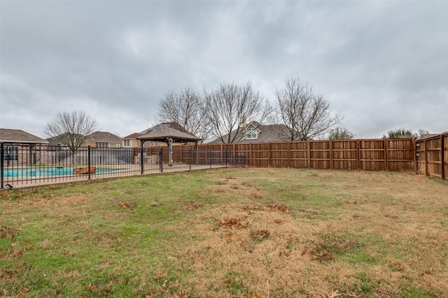 view of yard featuring a gazebo, a fenced backyard, and a fenced in pool