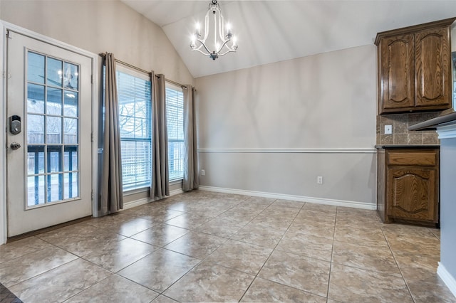 unfurnished dining area with lofted ceiling, a notable chandelier, and light tile patterned floors