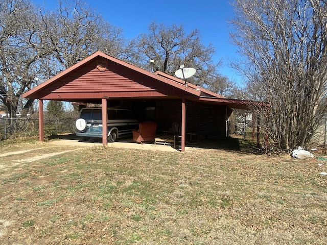 exterior space with a carport and fence