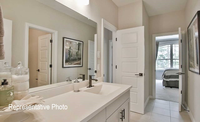 bathroom with tile patterned floors, connected bathroom, vanity, and baseboards