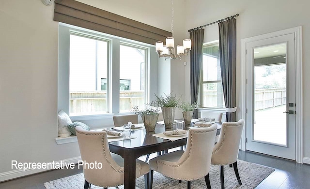 dining room with wood finished floors, a wealth of natural light, and a chandelier