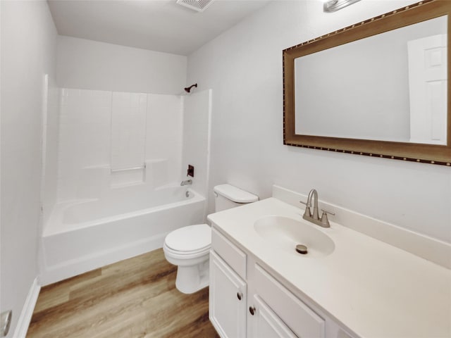 full bath featuring vanity, wood finished floors, visible vents, bathtub / shower combination, and toilet