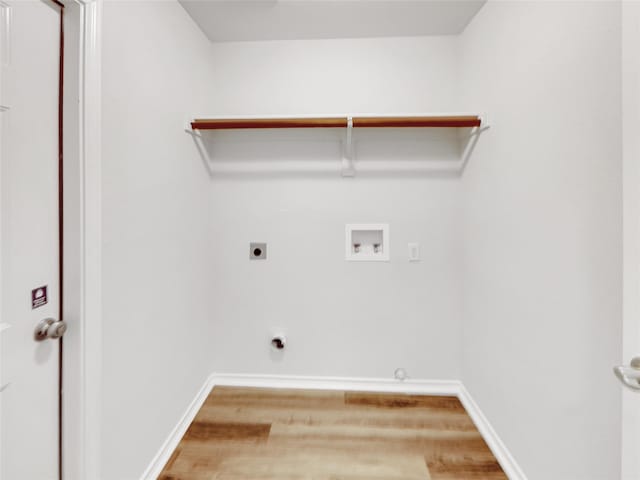 laundry area featuring baseboards, laundry area, hookup for a washing machine, wood finished floors, and electric dryer hookup