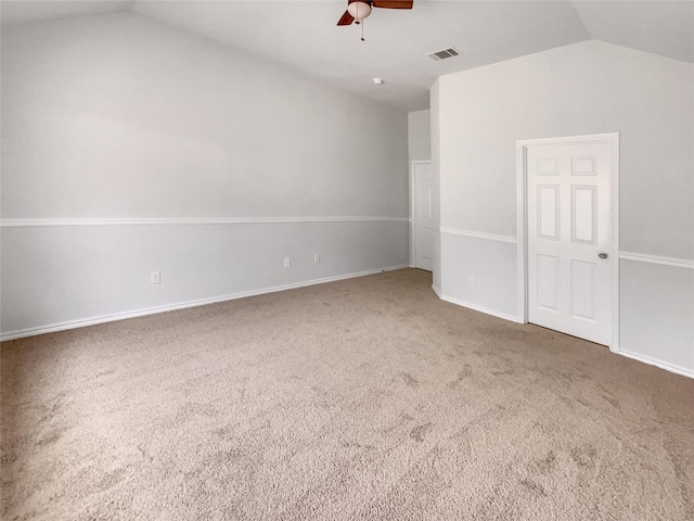 unfurnished bedroom with baseboards, visible vents, ceiling fan, vaulted ceiling, and carpet flooring