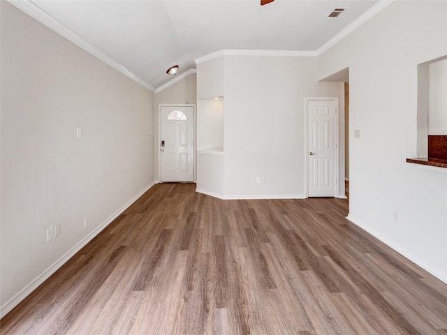 unfurnished living room featuring wood finished floors, visible vents, baseboards, ceiling fan, and ornamental molding