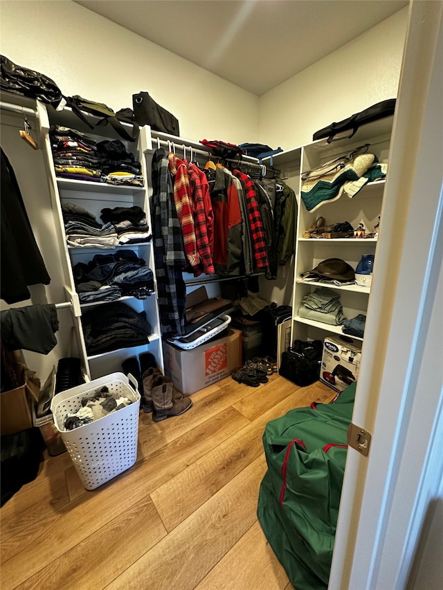 walk in closet featuring wood finished floors