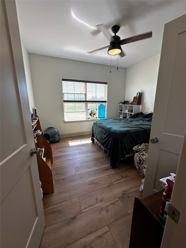 bedroom with ceiling fan and wood finished floors