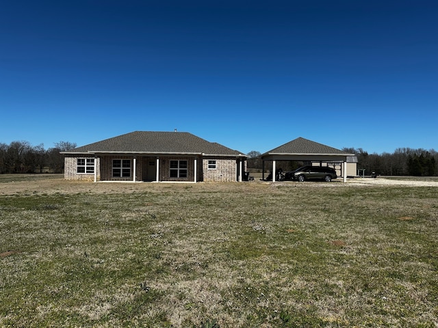 rear view of property featuring a yard