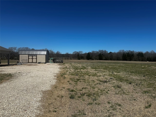 view of yard with an outbuilding and a shed