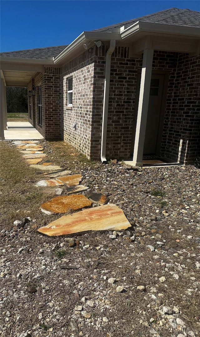 view of side of home with brick siding